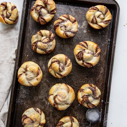 Pan of Chocolate Hazelnut Twists on a white table from overhead.