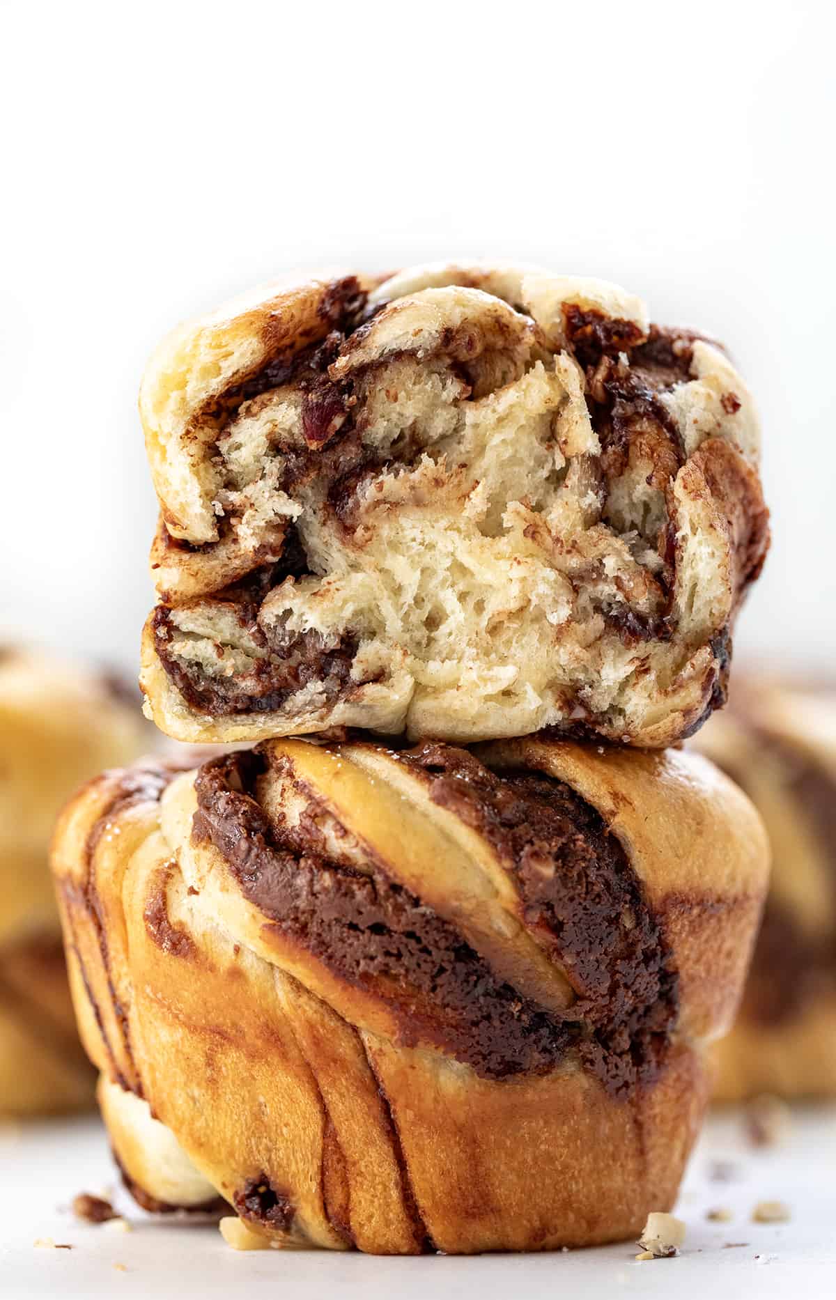 Close up of Chocolate Hazelnut Twists with top twist halved showing inside texture.