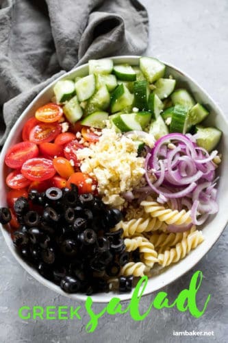 This Greek Salad is a combination of pasta, olives, juicy ripe cherry tomatoes, red onions, crunchy cucumbers and salty feta. Perfect for lunch, dinner or any party!