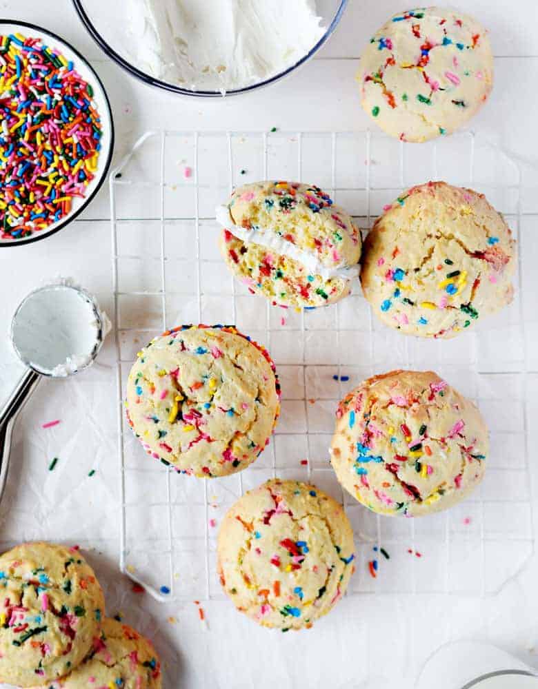 Easy Birthday Cake Sandwich Cookies on Wire Rack with Sprinkles and Frosting