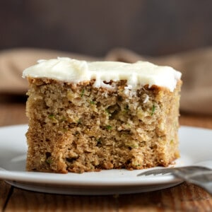 Piece of Zucchini Cake on a Plate with A bite Removed.