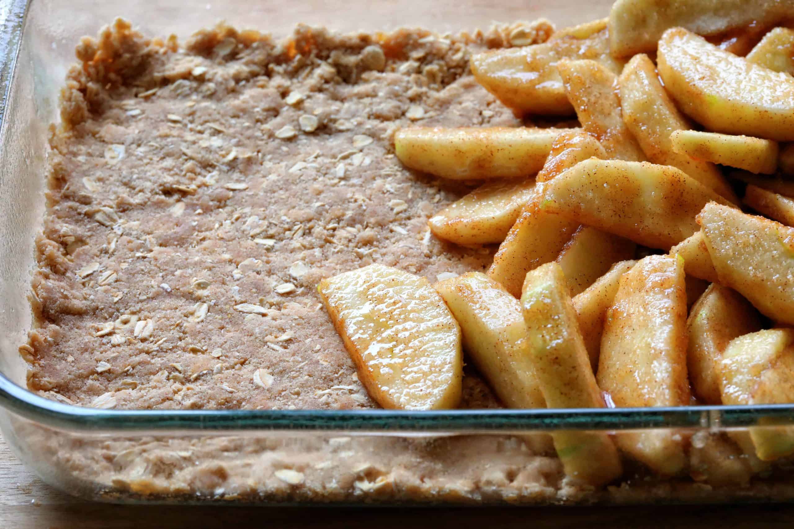 Pan Showing Bottom Layer of Double Crisp Apple Crisp with Apples on Top.