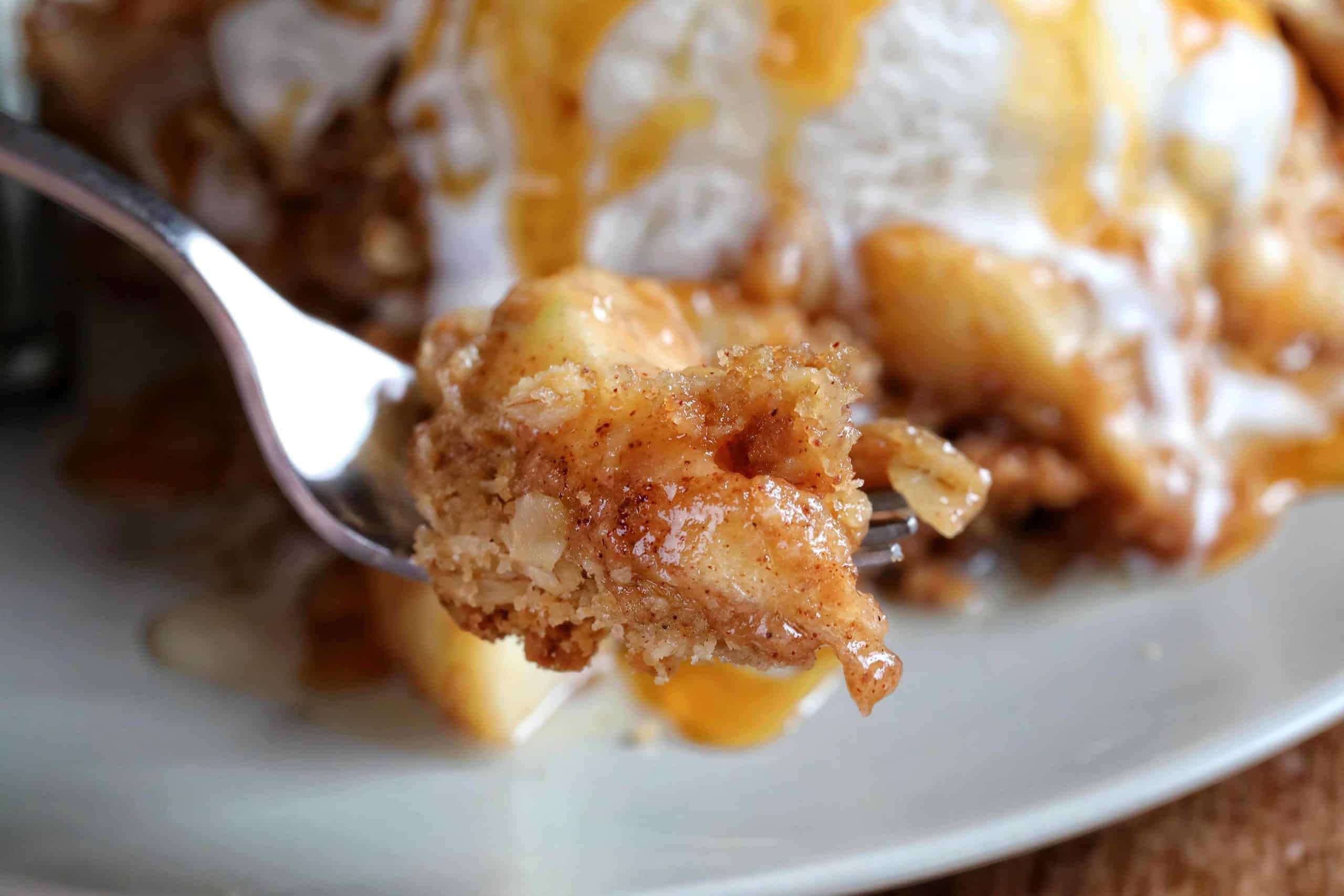 Apple Crisp Bite on a Fork with Ice Cream and Caramel