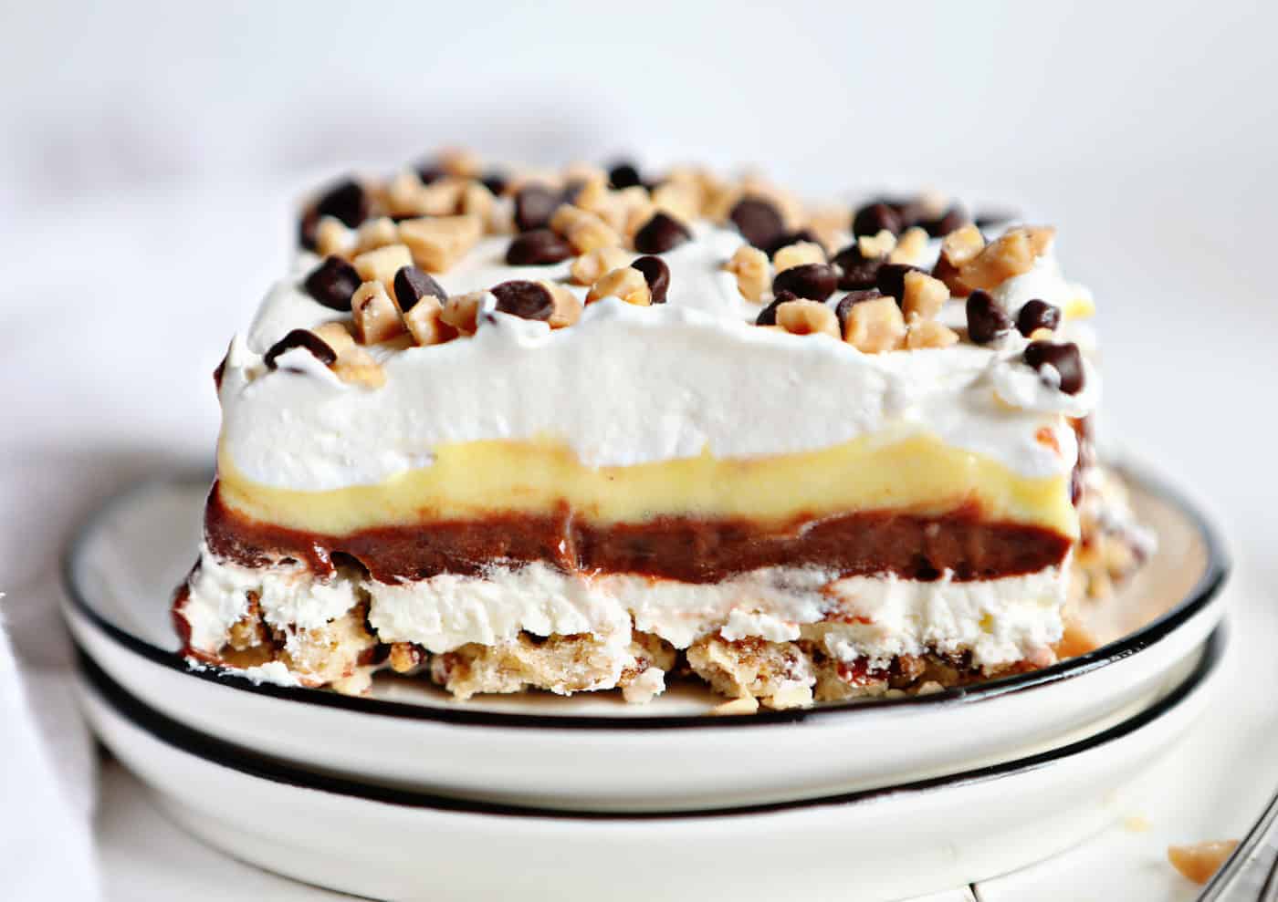 Woman taking baking pan with delicious pie from electric oven in