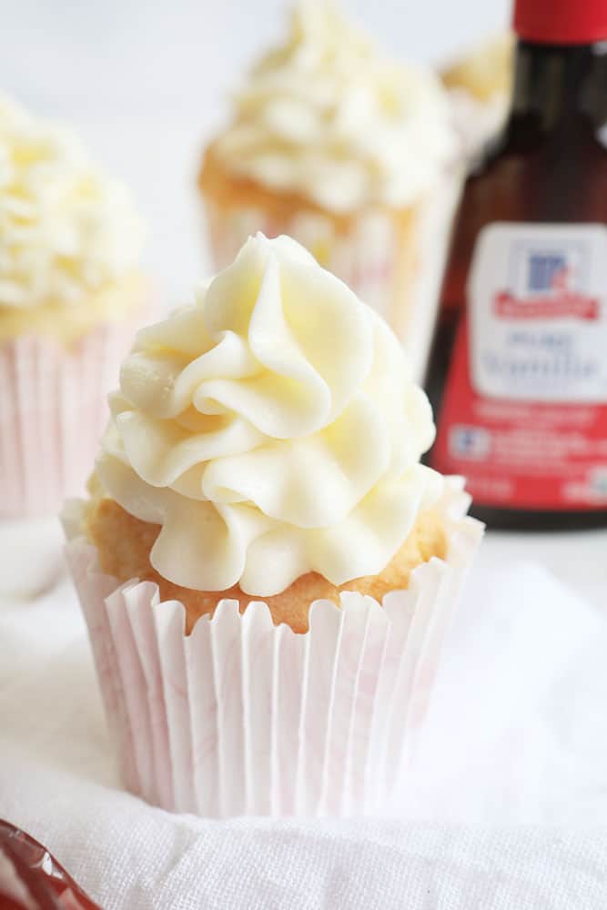 vanilla cupcakes with raspberry filling and cream cheese frosting