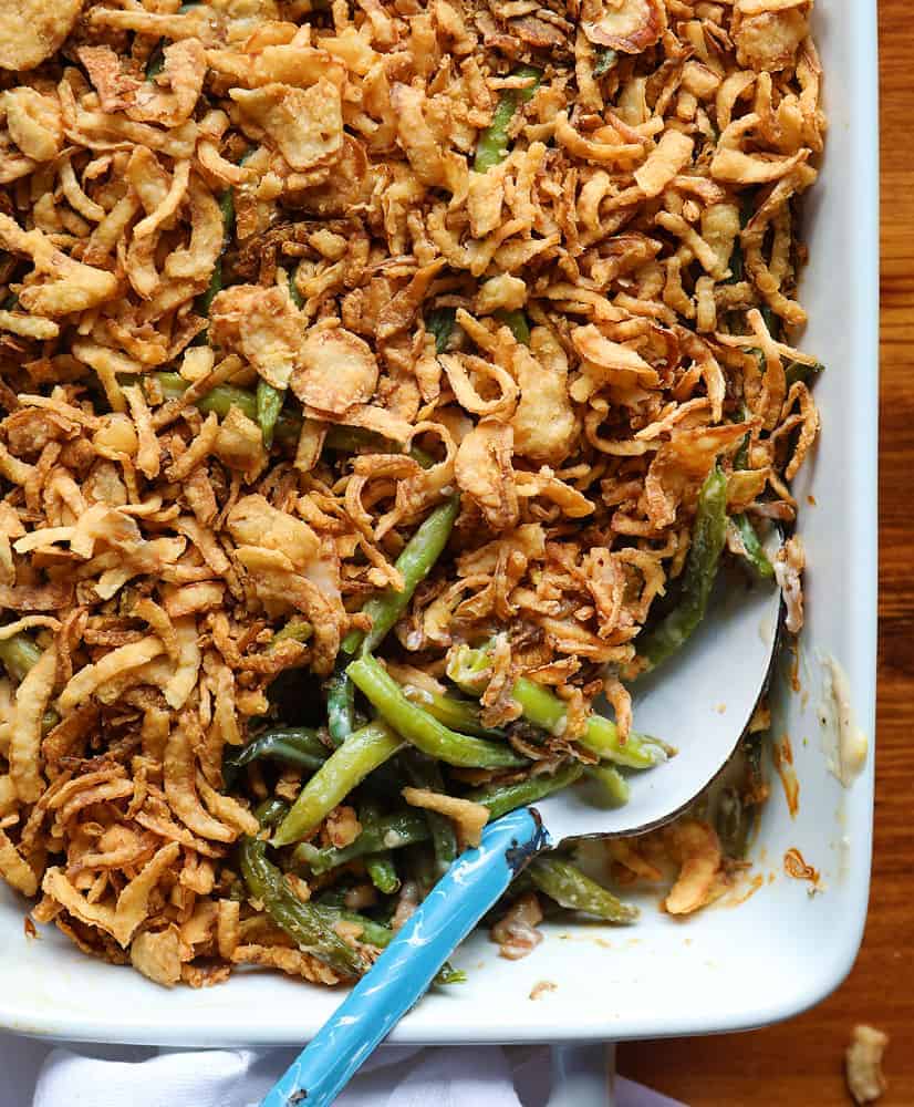 green bean casserole in serving dish with a serving spoon.  