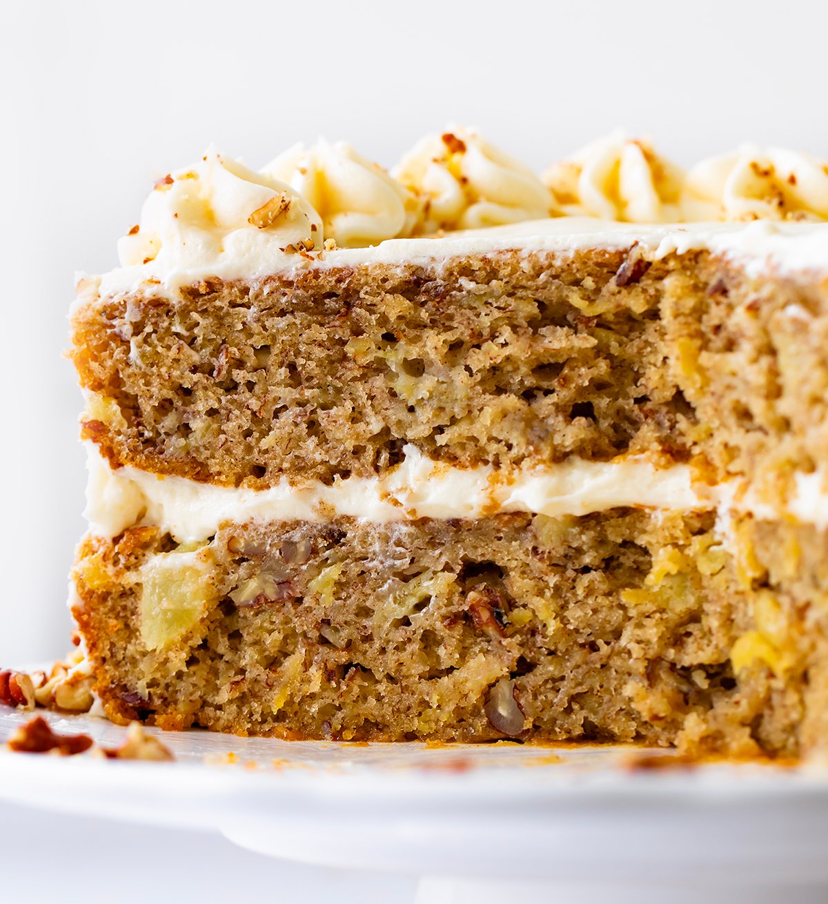 Hummingbird Cake on a Cake Stand with Pieces Removed Showing Inside.