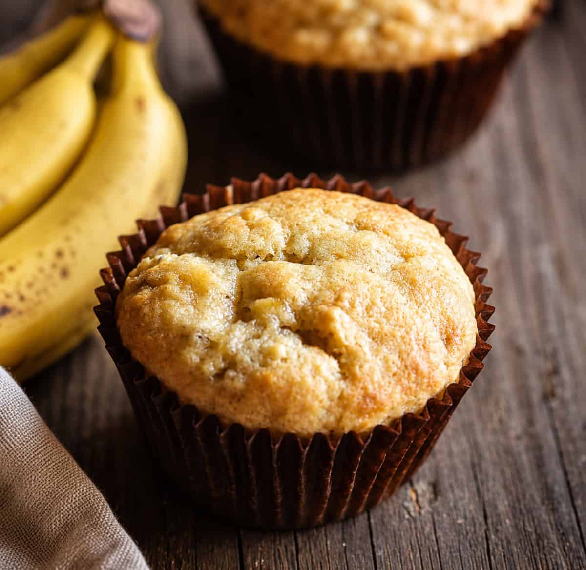 The purest, organic, delicious flavor of banana makes this the BEST Banana Muffin I have ever had! The secret to this recipe is DOUBLE the normal amount of banana! Close up of a banana muffin.