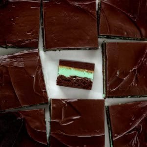 Fudgy Chocolate Mint Brownies cut into squares and the center sqaure on its side.
