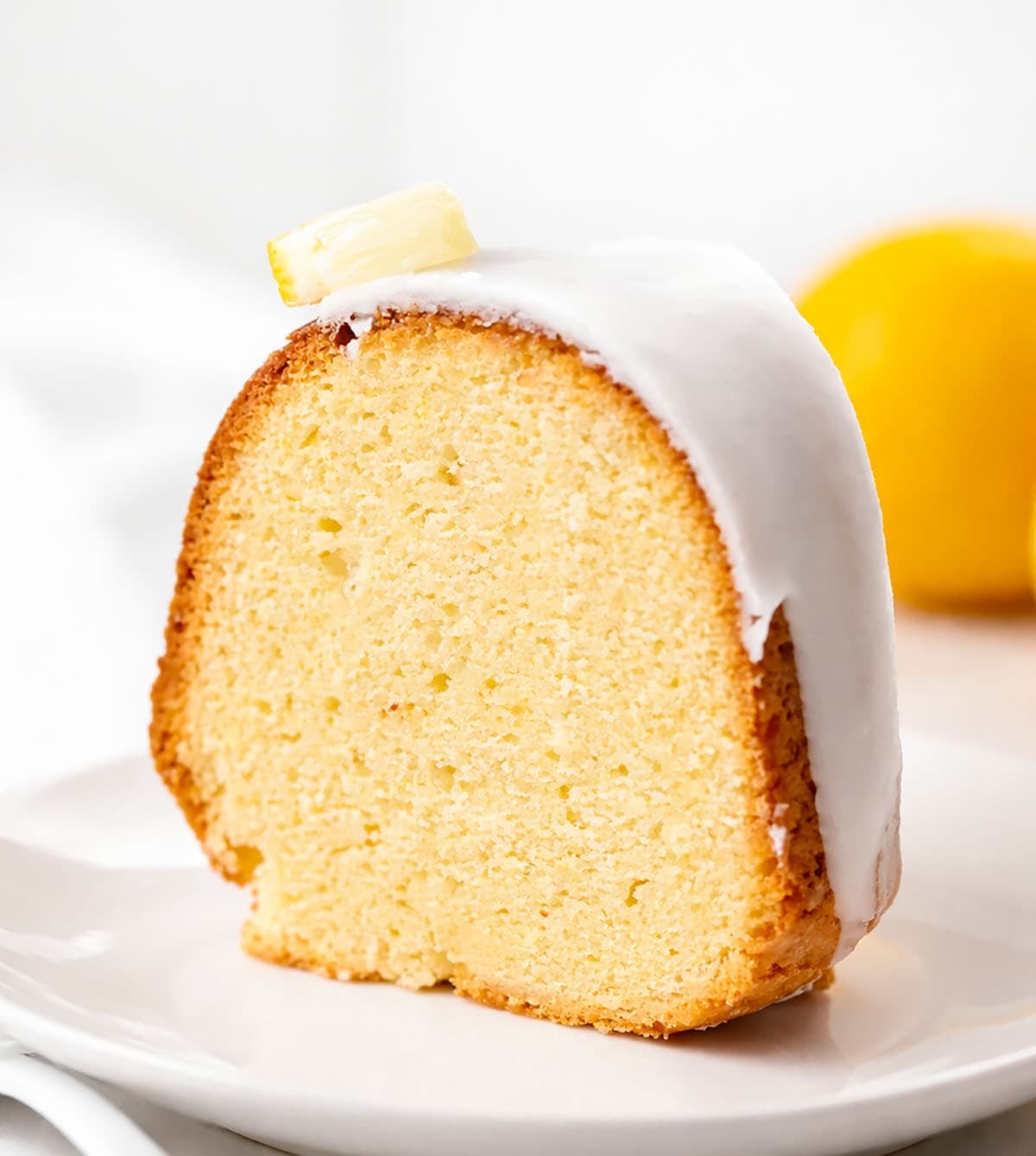Piece of Lemon Pound Cake on a white plate close up.