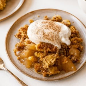 Plates of Apple Dump Cake on a white table.