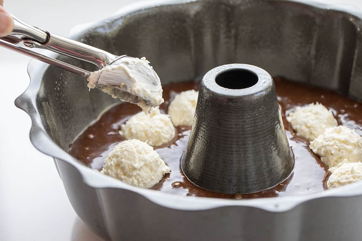 Adding Cream Cheese to Chocolate Cake Batter in Bundt Pan. Dessert, Baking, Chocolate, Chocolate Dessert, Bundt Cake, Cake, Cake Recipes, Filled Bundt Cake, Nothing but Bundts Cake, Baking Recipes, i am baker, iambaker