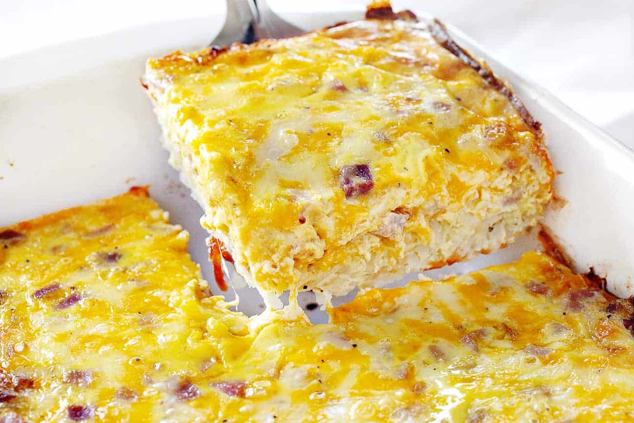 Cutting out a Piece of Ham and Cheese Breakfast Casserole