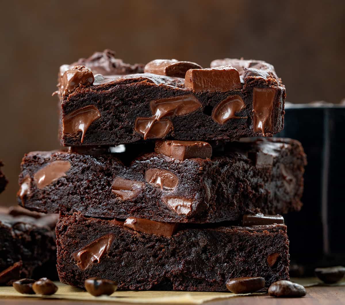 Stack of Mocha Brownies with Coffee Beans Around.