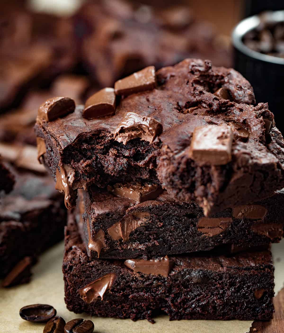 Stack of Mocha Brownies with Top Brownie Having a Bite Taken Out.