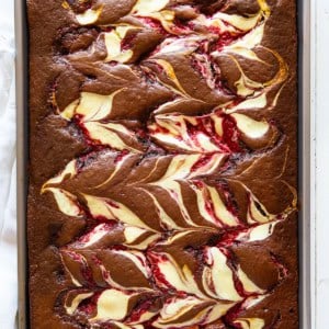 Raspberry Cheesecake Sheet cake on a white table from overhead.