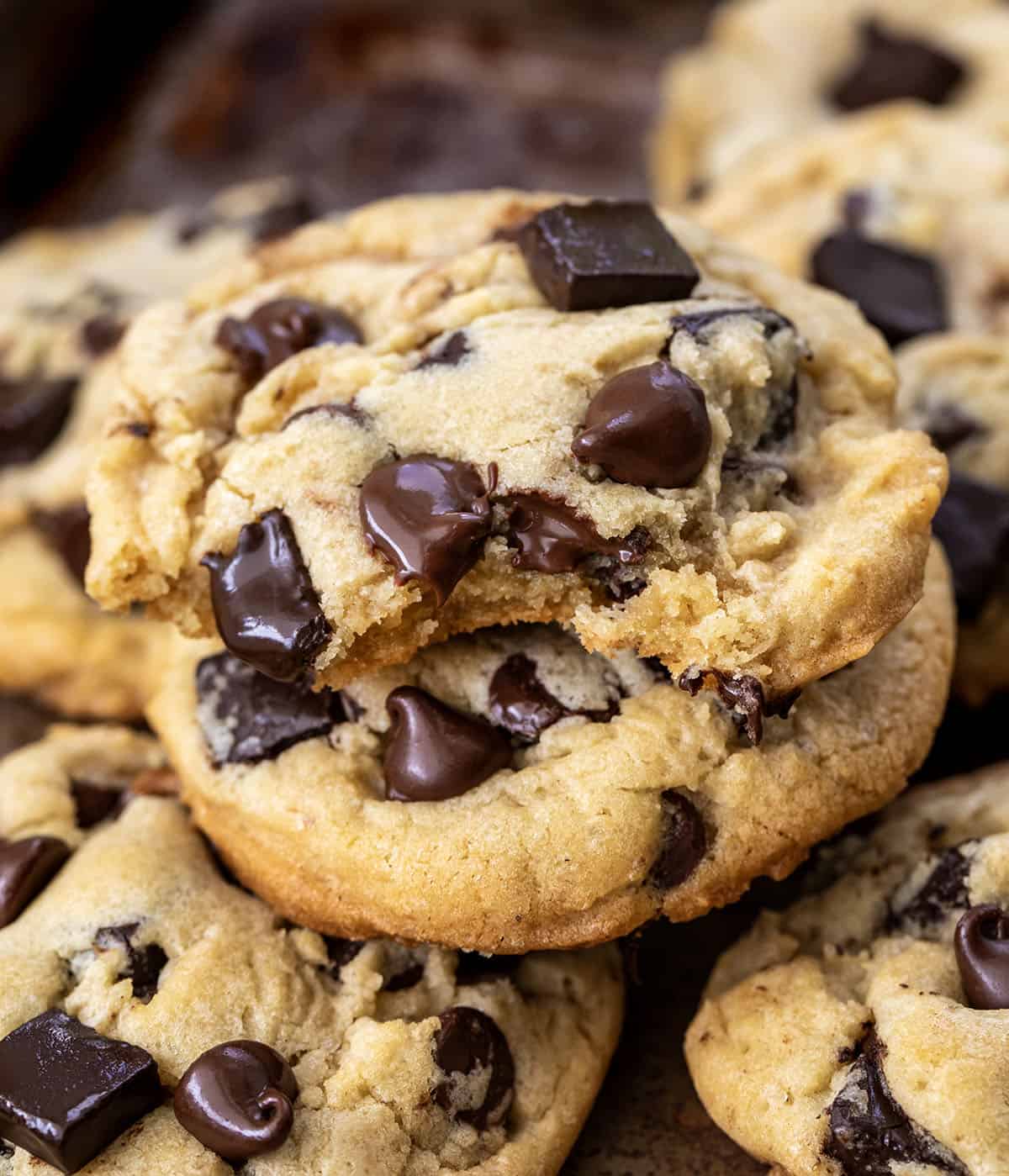 Close up of Chocolate Chip Cookies with the top cookie bitten into.