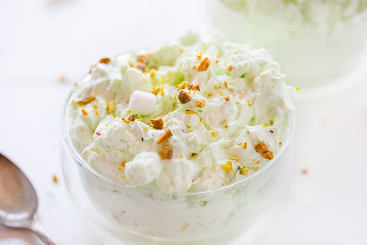 Pistachio Fluff or Watergate Salad on a Bowl with Chopped Pistachio on Top.