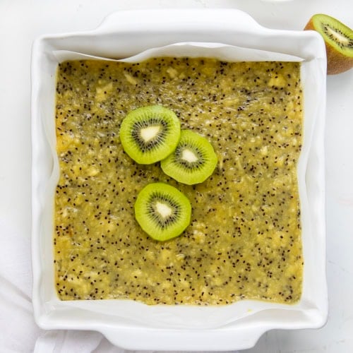 Pan of Kiwi Bars on a white table from overhead.