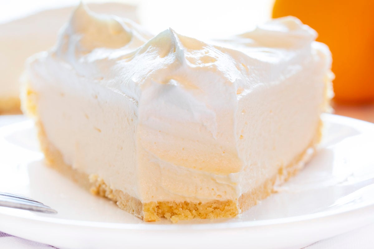 Orange Creamsicle Pie on Plate with One Bite Removed Showing Inside.