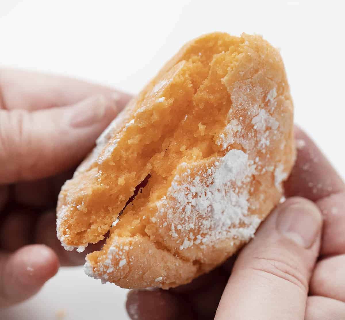 Breaking Open an Orange Creamsicle Cookie with Hands