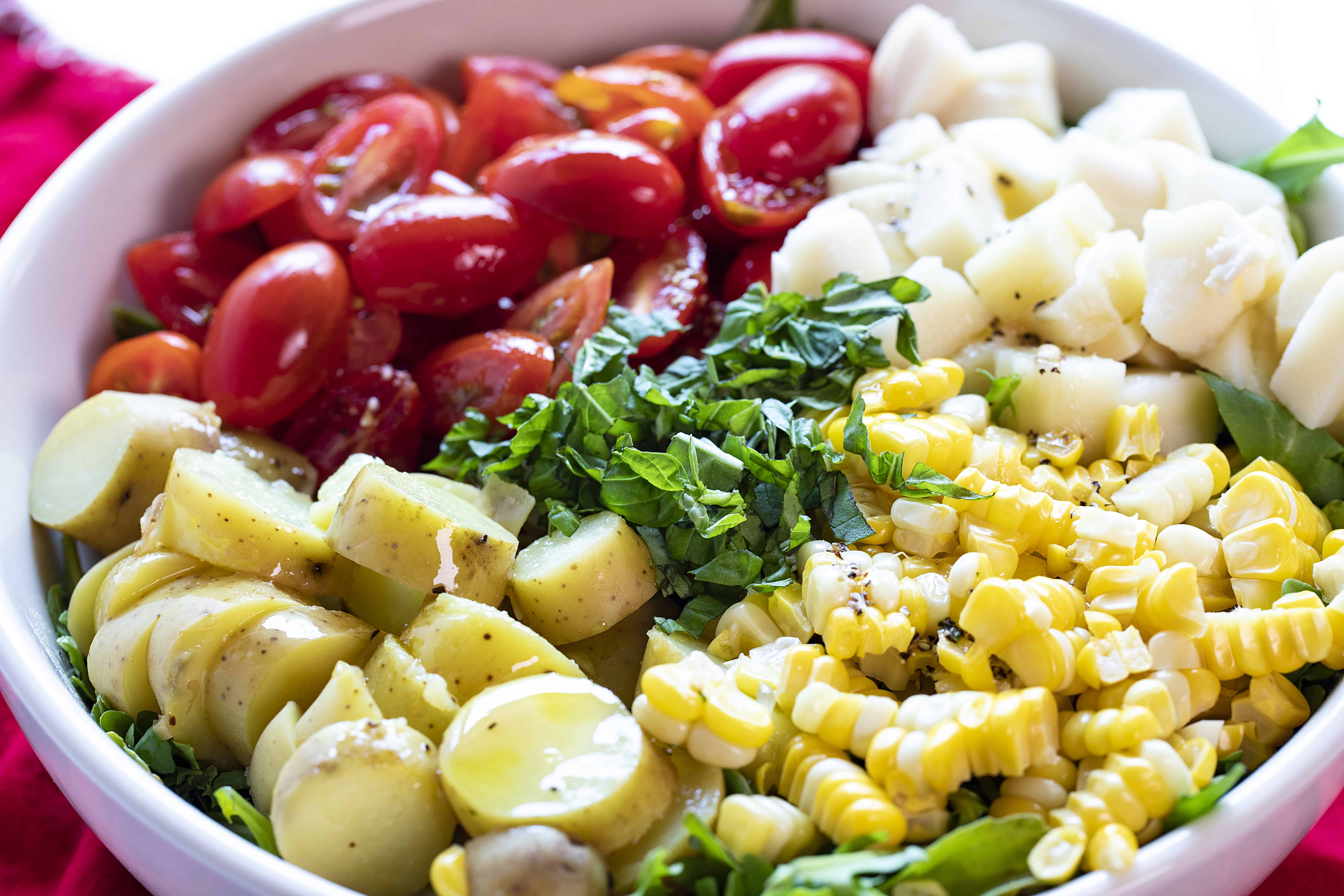 Beautiful Ingredients for the Perfect Summer Salad! Tomatoes, Corn, Potatoes all on Lettuce.