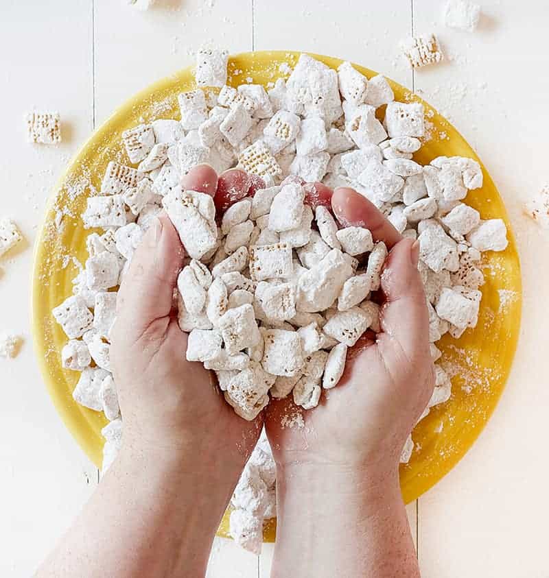 Hands full of Banana Pudding Puppy Chow