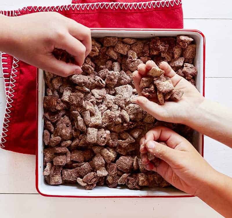 Grabbing a handful of Brownie Puppy Chow