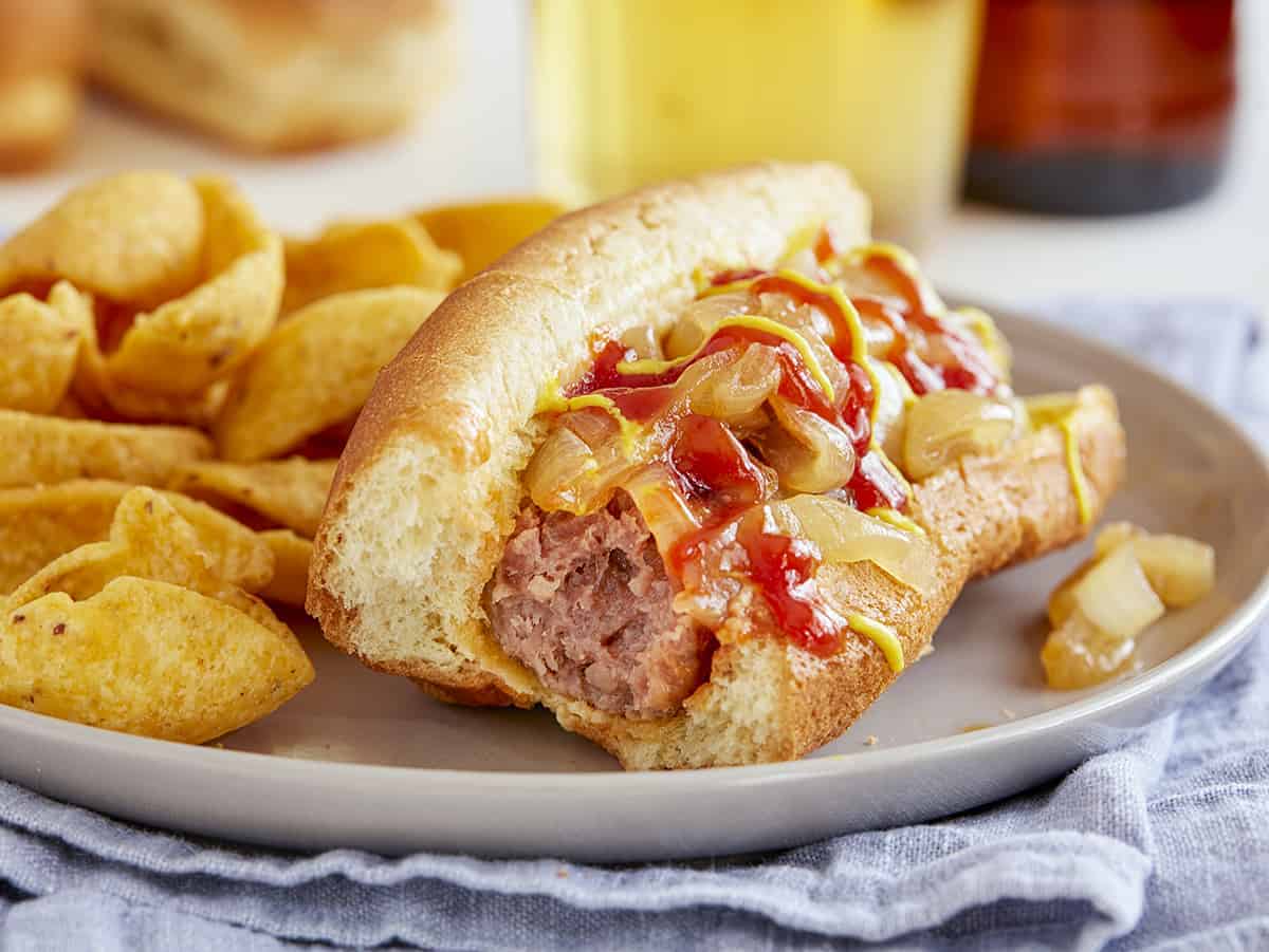 Bite From A Slow Cooker Beer Brat with Caramelized Onions