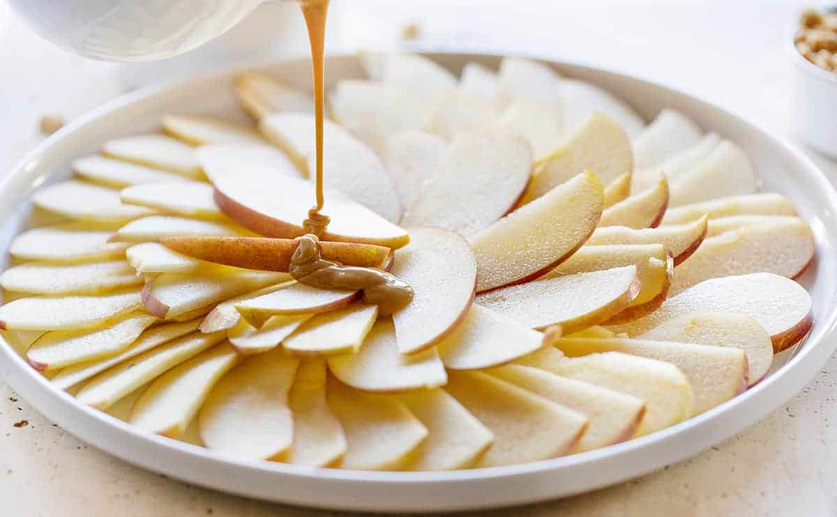 Apples Being Drizzled with Warm Peanut Butter