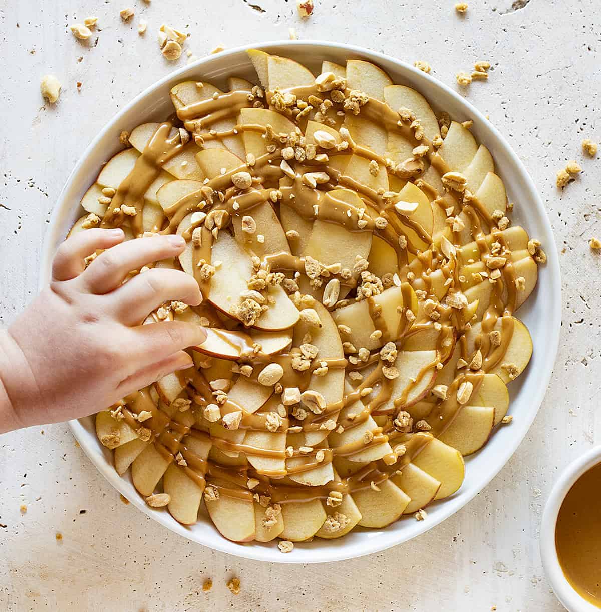 Apple Nachos with Child Picking One Up