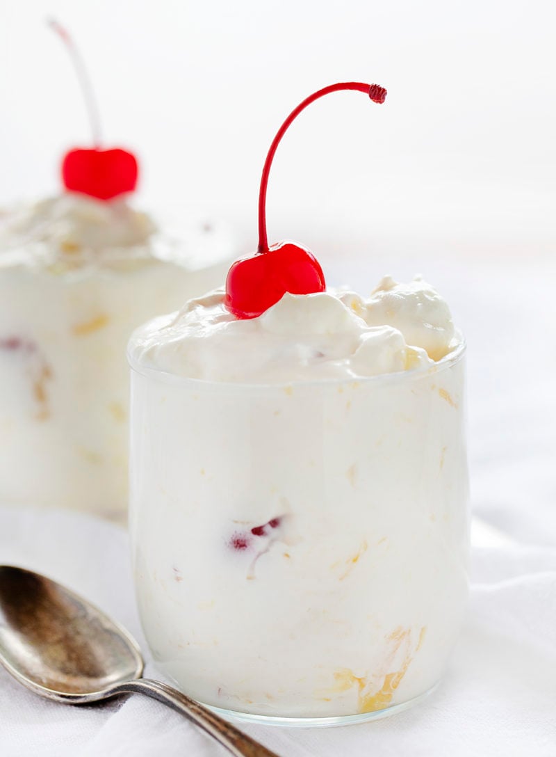 Pineapple Fluff in Glasses with Spoons and Cherries on Top.