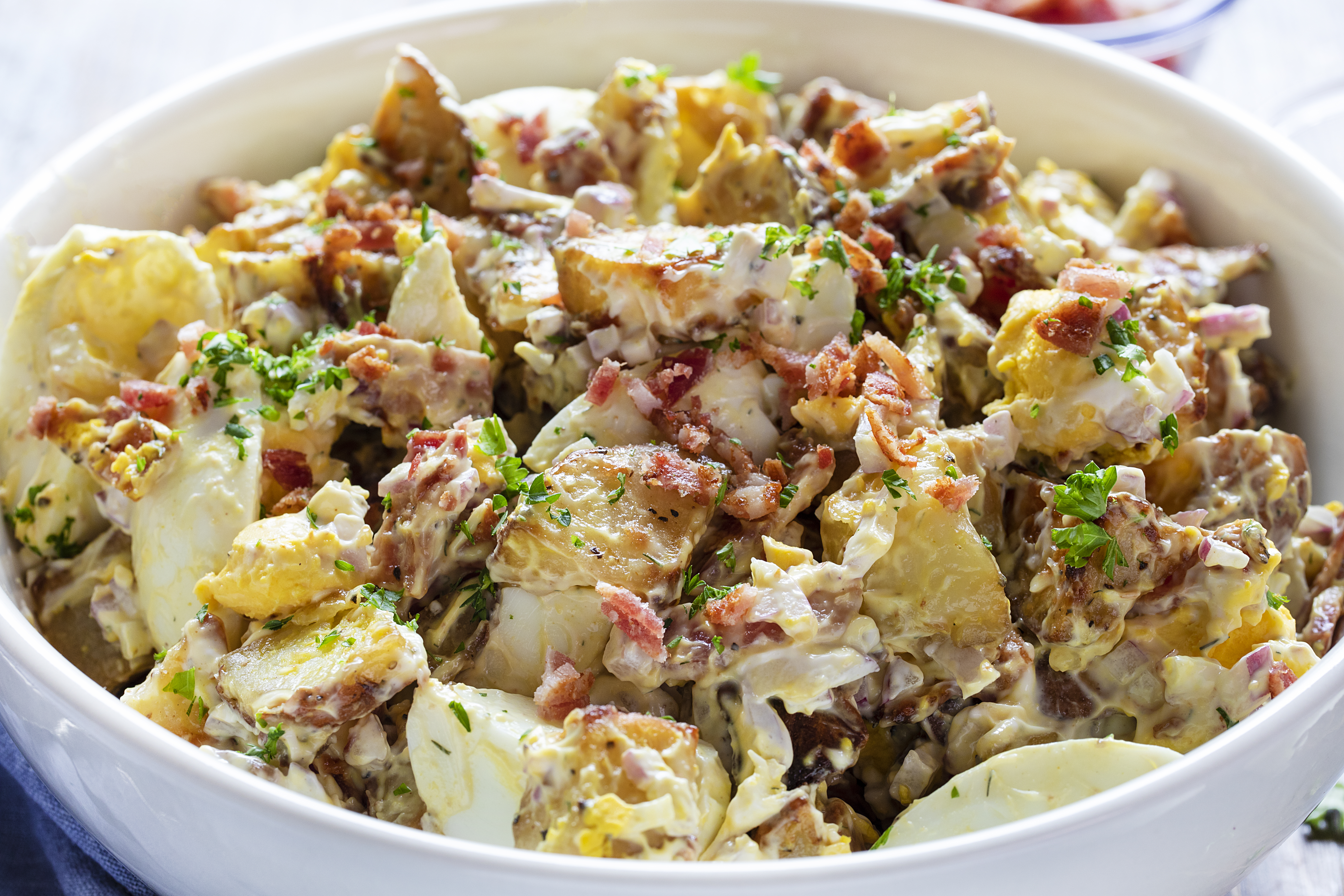 Roasted Potato Salad in a White Bowl in Natural Light.