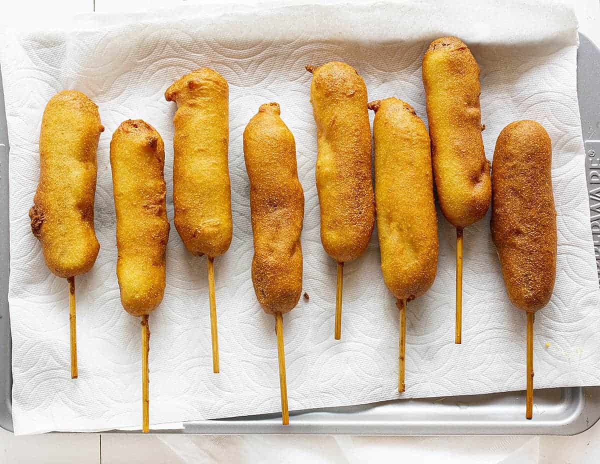 Eight pronto pups on a paper towel-lined serving dish