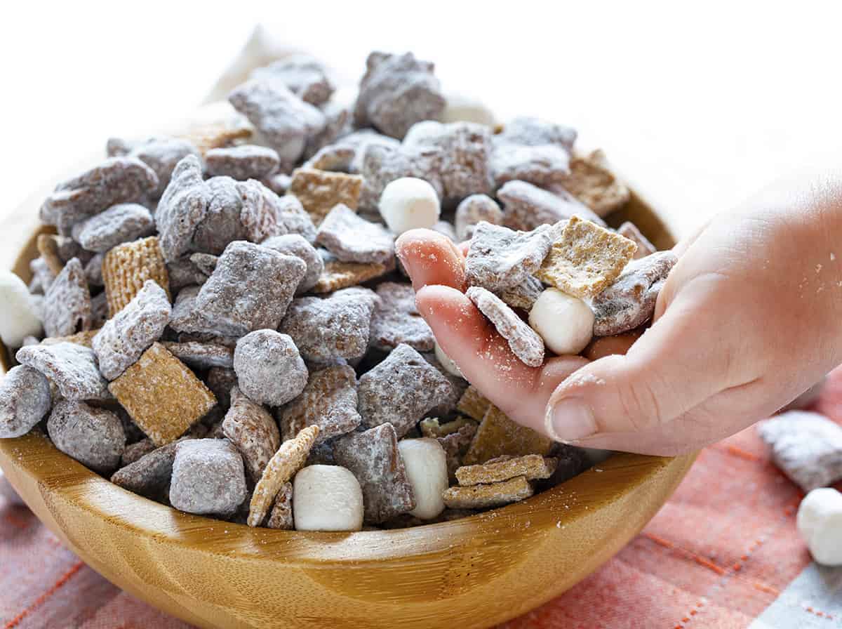 Child Holding Handful of S' Mores Puppy Chow