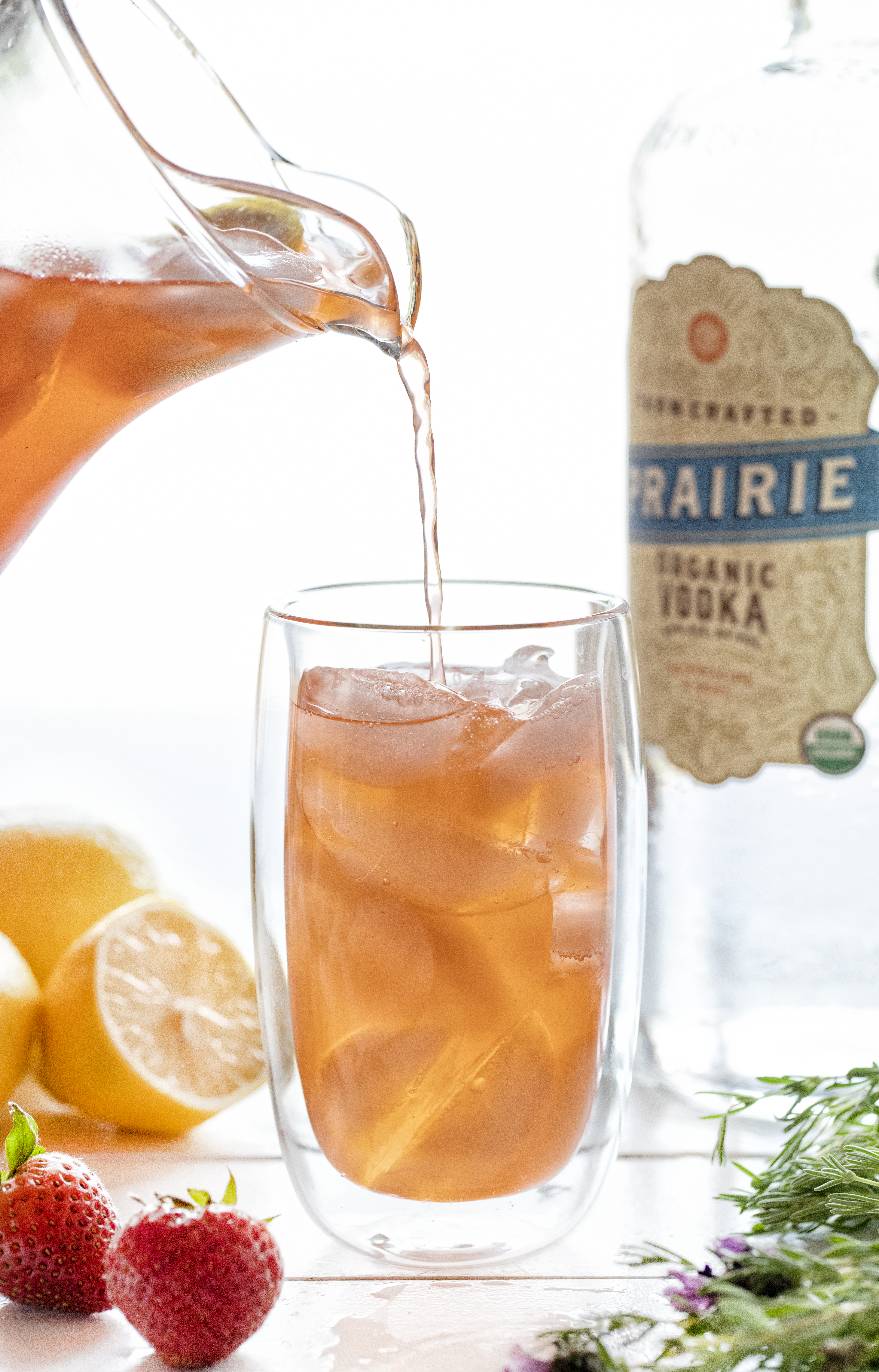 Strawberry Lavender Vodka Lemonade Being Poured Into Glass