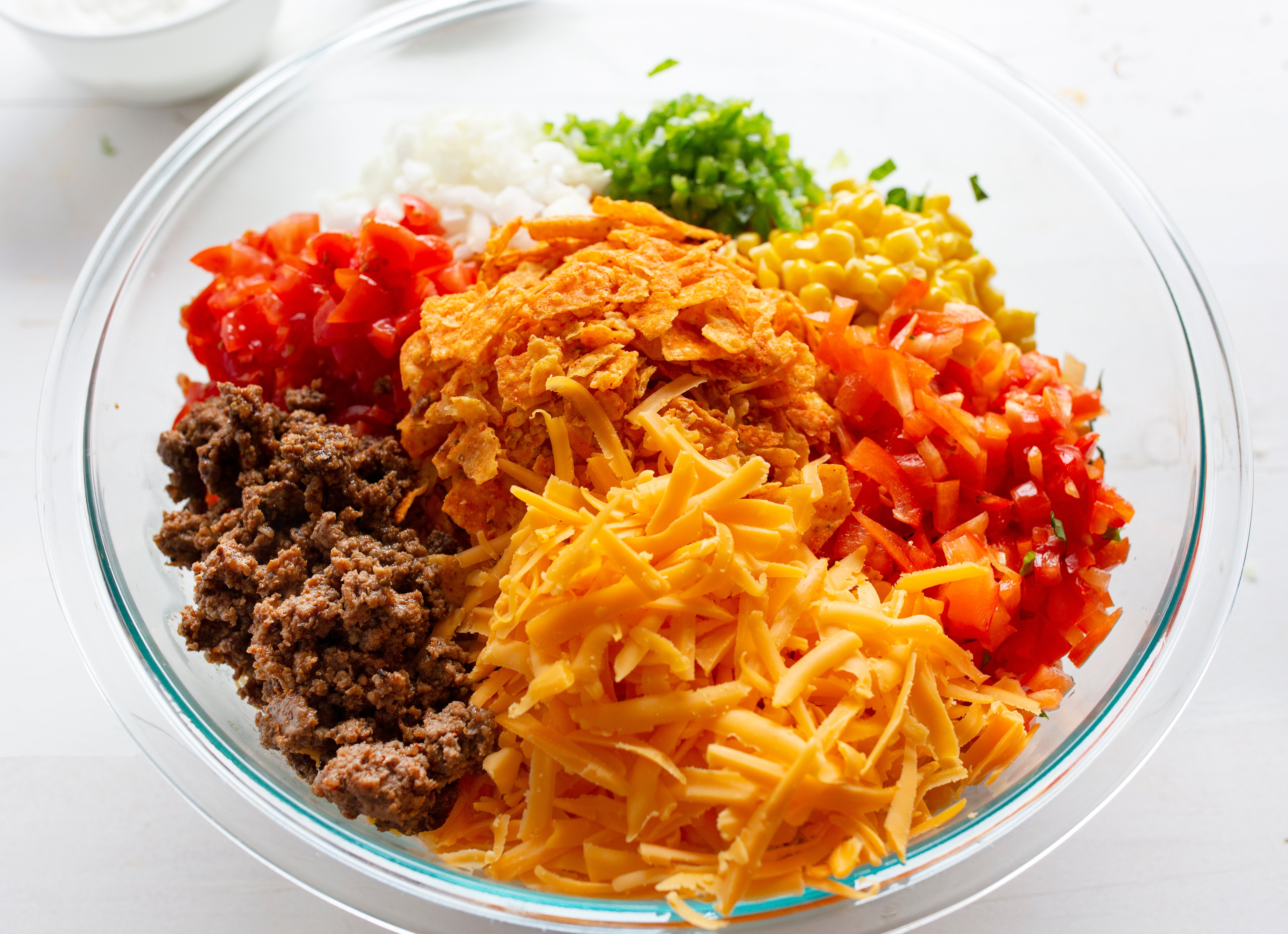 Taco Salad will make taco night a hit in your house again! taco, tacos, taco salad, taco fixings, dorito salad, dorito taco salad, salad, summer salad, summer salad recipes, taco recipes, taco salad recipes, dorito taco recipe, iambaker, i am baker, bbq recipes, cookout recipes, summer recipes, french dressing salad Dorito Taco Salad Ingredients in a Bowl Before Mixing Together.
