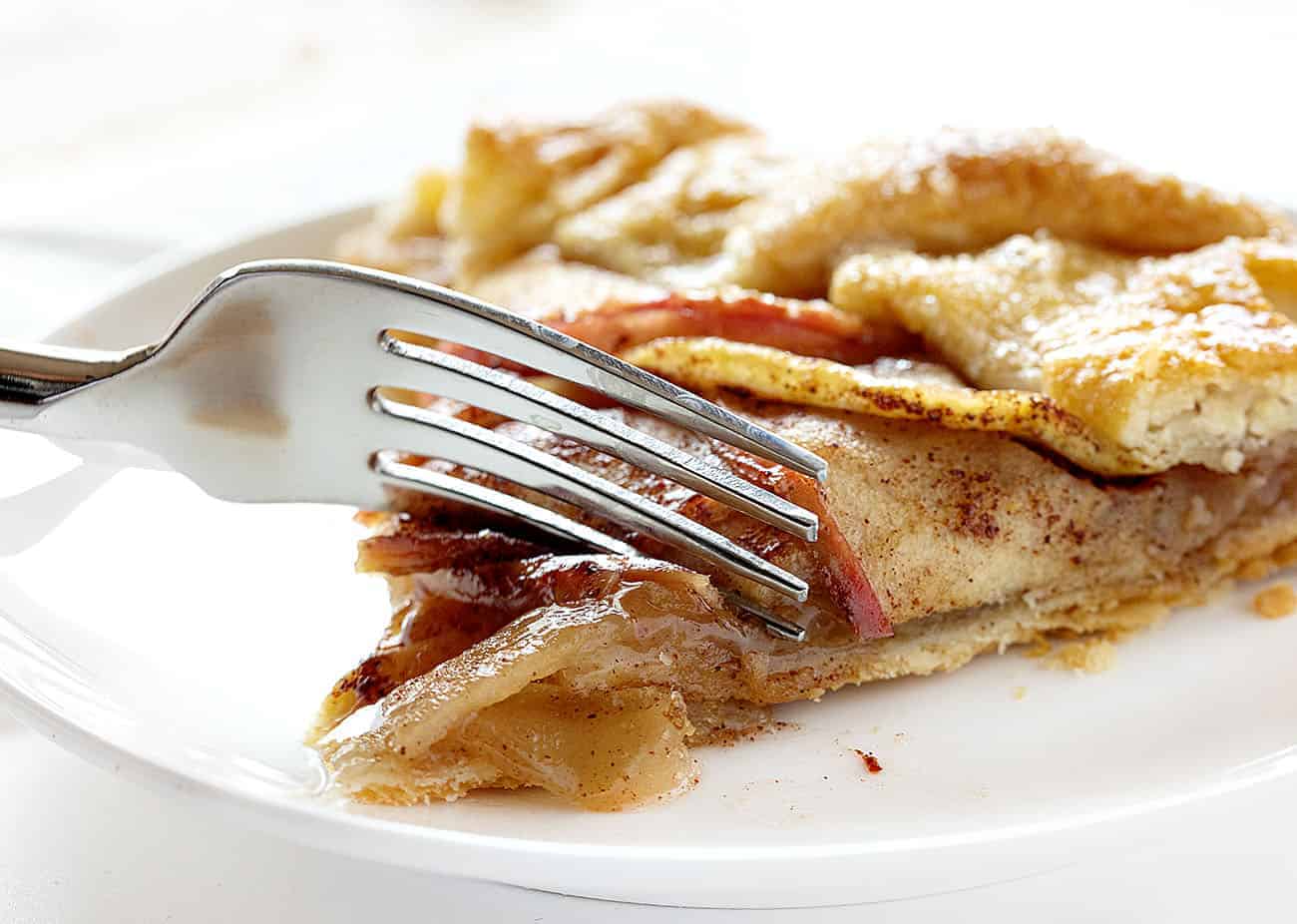 Fork cutting into Homemade Apple Galette