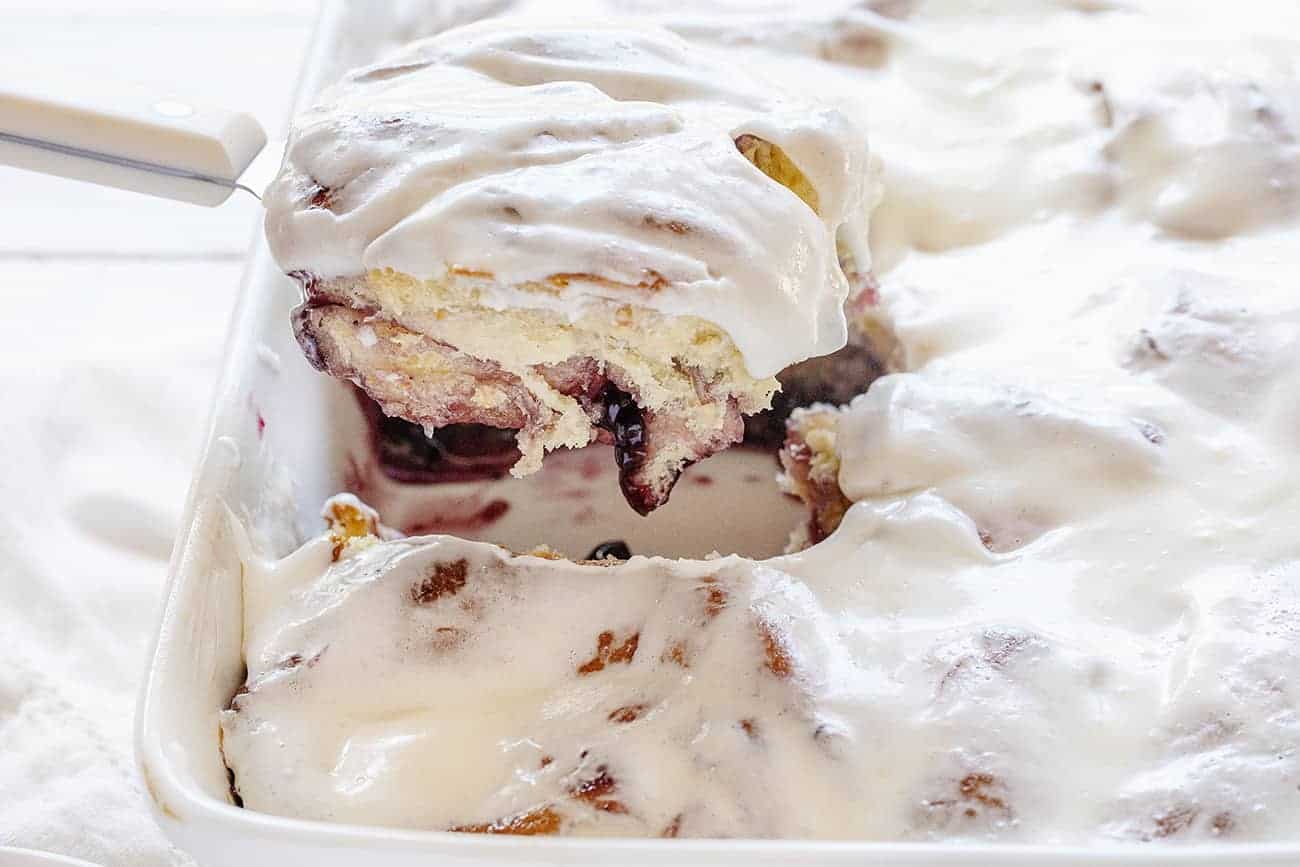 Removing a Piece of Blueberry Lemon Sweet Rolls From a Pan