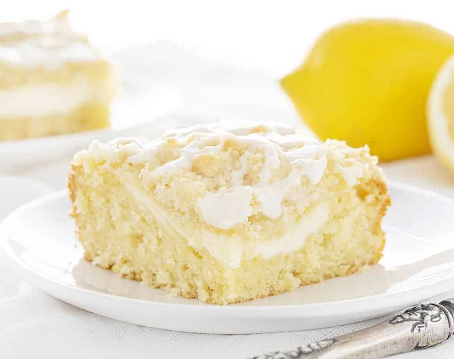 This Lemon Cream Cheese Coffee Cake is completely from-scatch and loaded with pure lemon flavor! The best way to start the day! #lemoncoffeecake #lemoncreamcheesecake #coffeecake #breakfastcake #lemonbreakfastcake #bakedlemoncake #baking #recipes #breakfast #iambaker Slice of Lemon Cream Cheese Coffee Cake