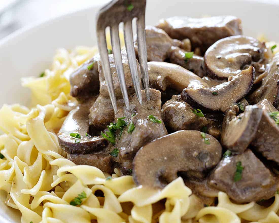 Fork taking a bite of Beef Stroganoff