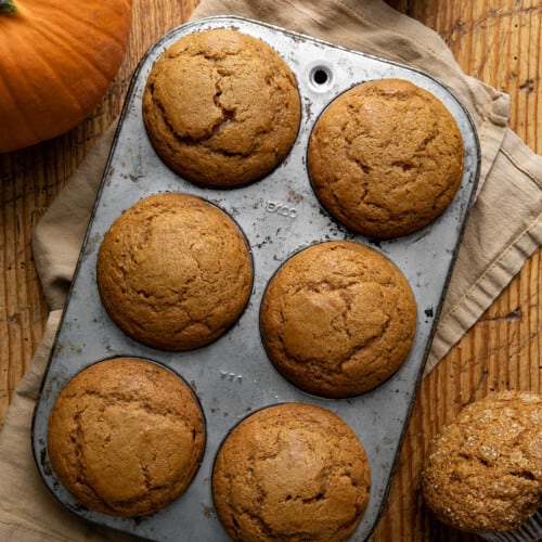 Pumpkin Spice Muffins in a Muffin Pan on a Table from Overhead.
