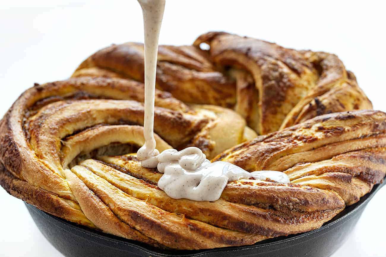 Pouring glaze over Pumpkin Spice Bread Twist