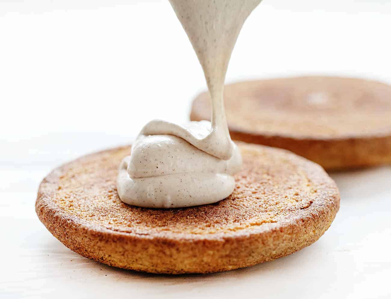 Colossal Snickerdoodle Cookie with Frosting Being Dropped on