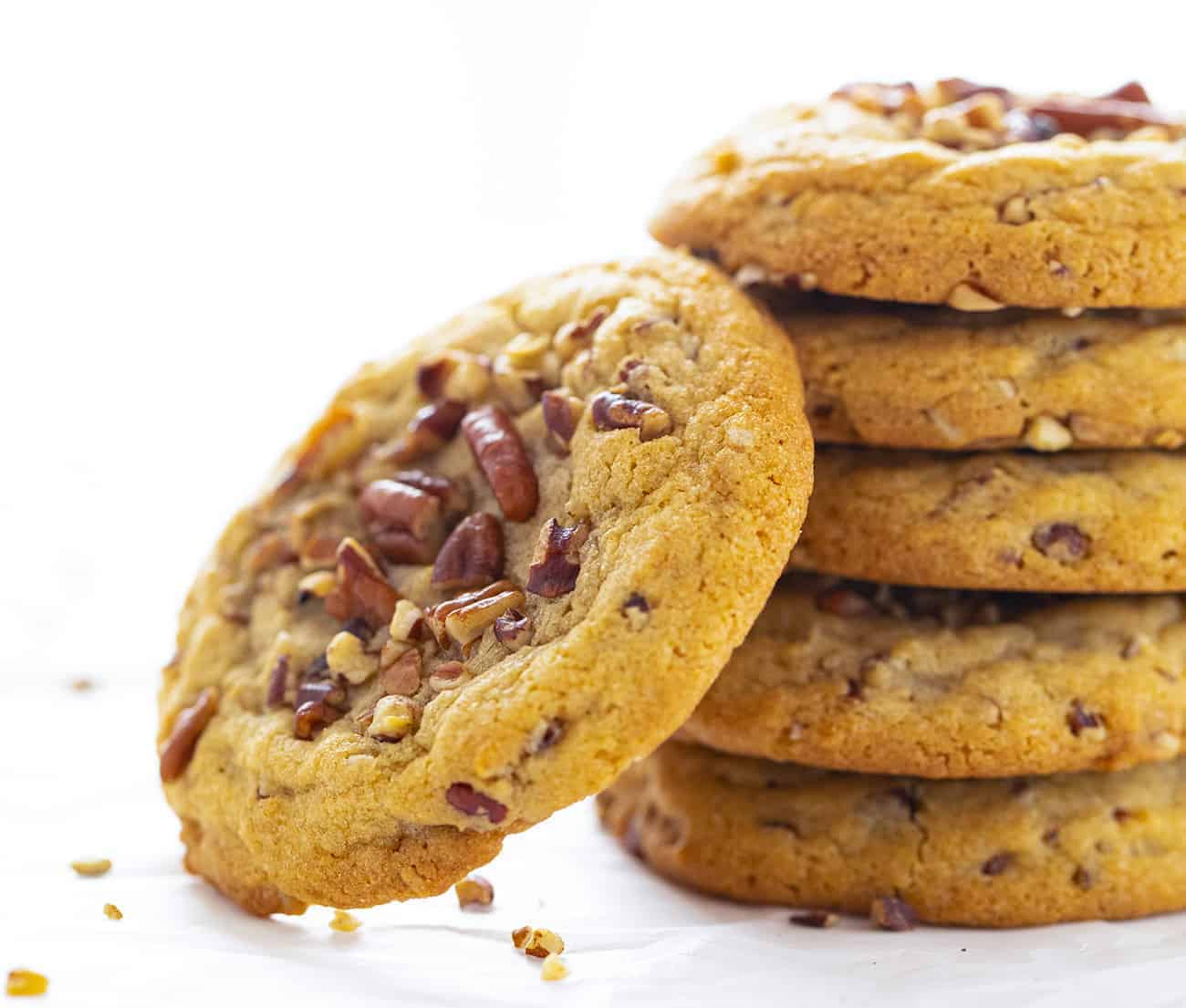 Stack of Butter Pecan Cookies with One Cookie Leaning