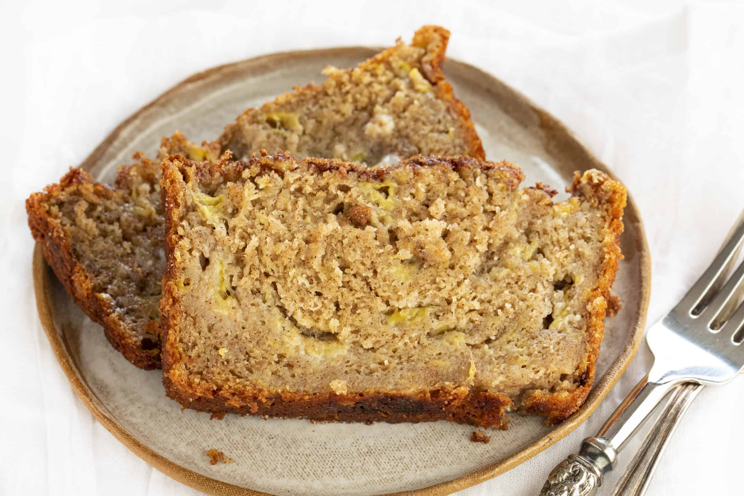 Two pieces of Cinnamon Sugar Banana Bread on a plate