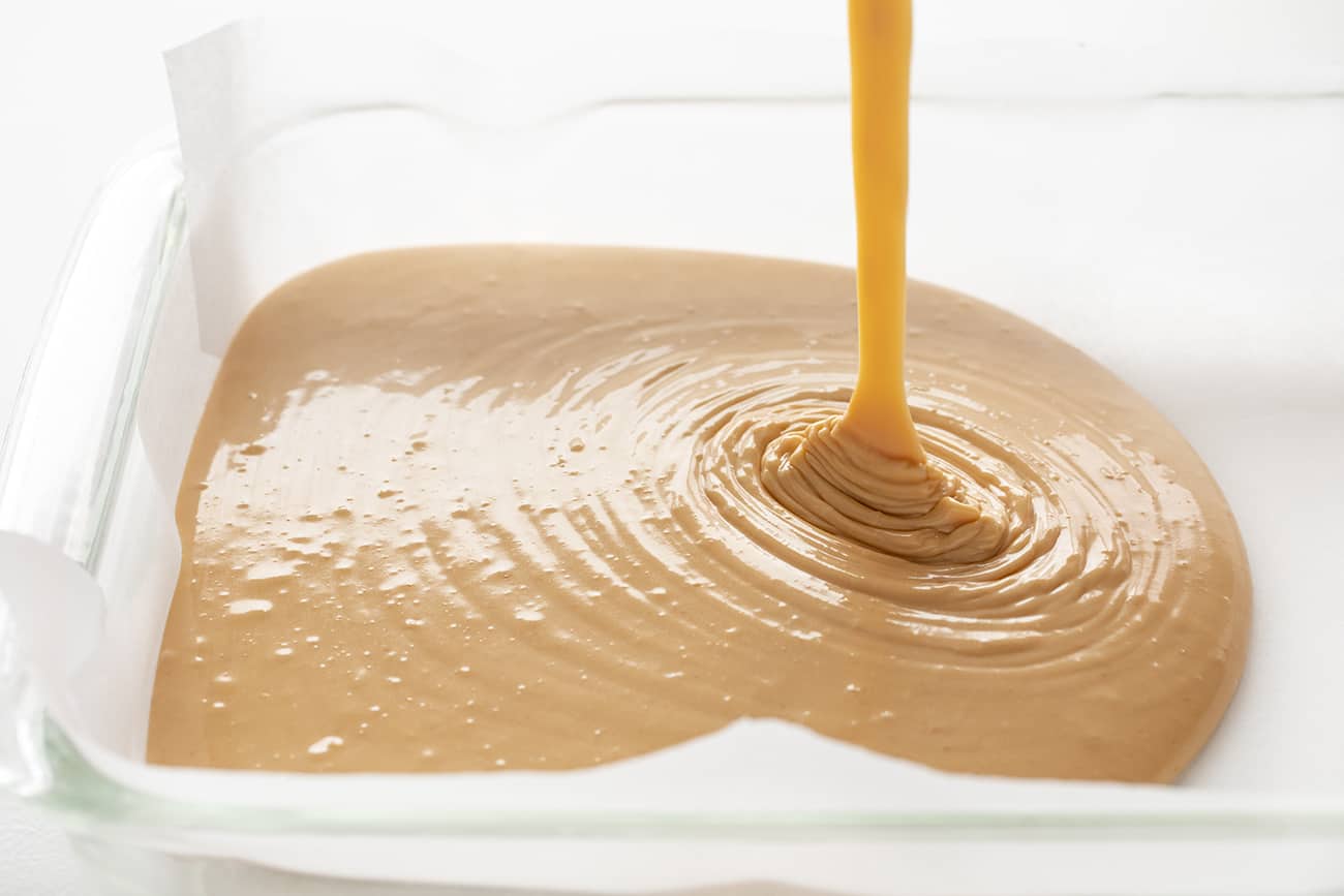 Creamy Peanut Fudge Being Poured Into Pan