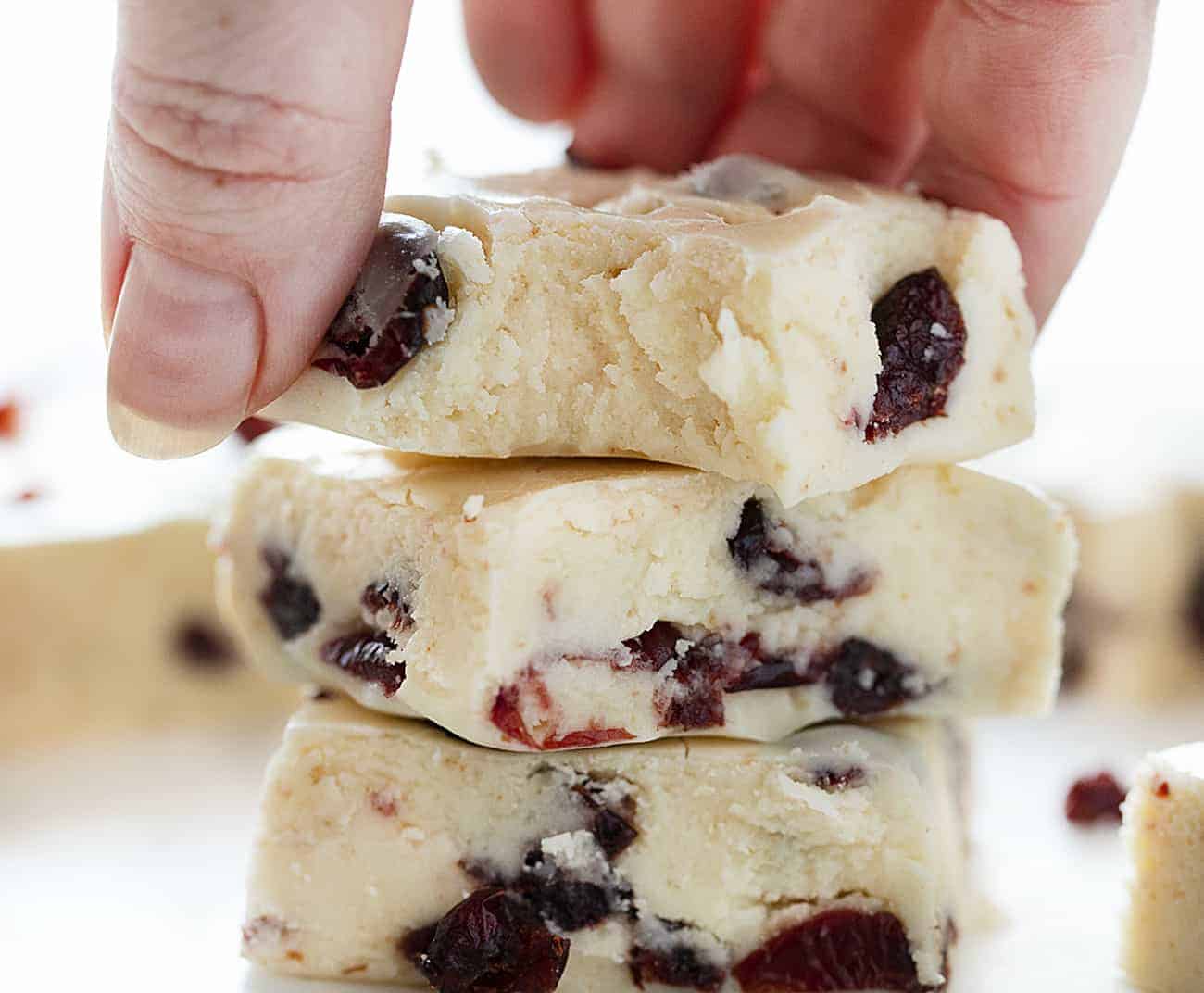 White Chocolate Cranberry Fudge Stacked and Being Picked Up