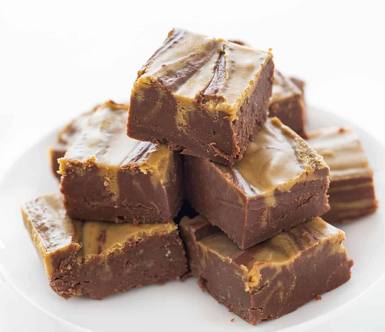 Stacked Chocolate Peanut Butter Fudge on a White Plate