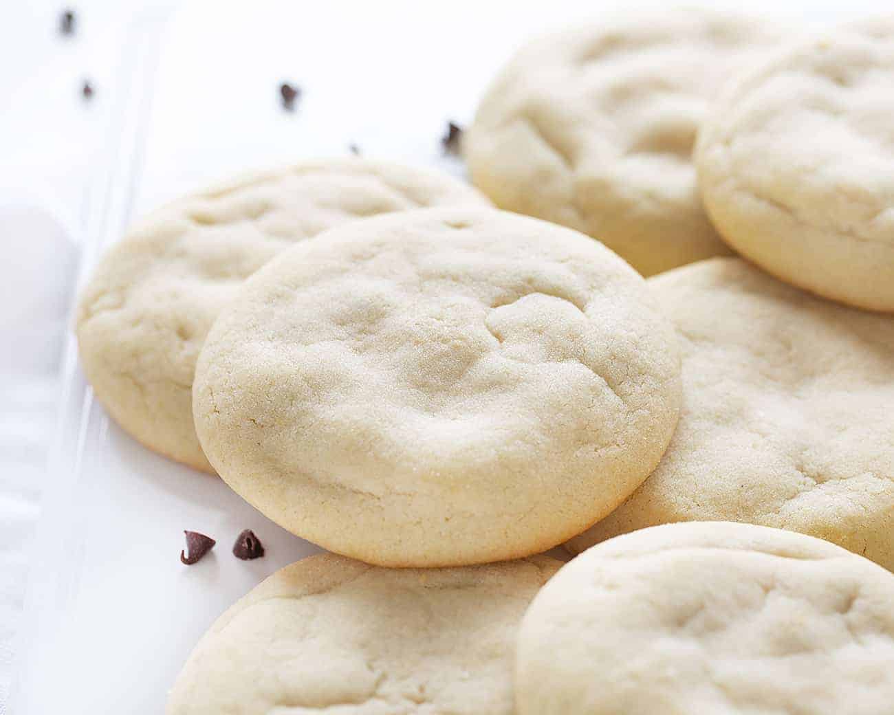 Sugar Cookies with Chocolate Chip Cheesecake Filling Stacked on White Plate